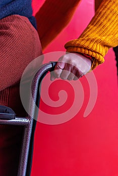 Woman`s hands pushing a wheelchair