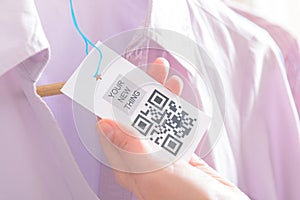 Woman`s hands with a qr code label
