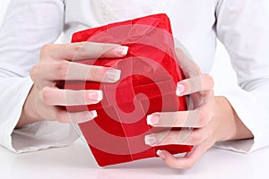 Woman's Hands On Red Velvet Gift Box