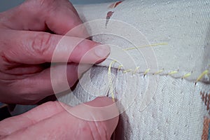 Woman`s Hands Sewing textire. Hobby and work.