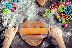 Woman's hands sheeting dough with rolling pin