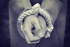 Woman`s hands are tied with rope. The concept of freedom and human rights. Violence and social problems.