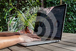 Ruky prenosný počítač analytická na písací stôl v záhrada na čerstvý vzduch 