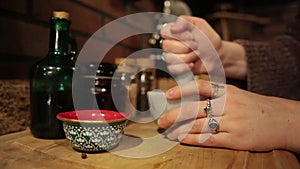 Woman`s hands vigorously grind, stir and crush ingredients in mortar and pestle