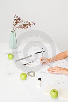 woman's hands working on drawings