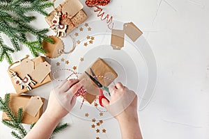 Woman`s hands wrapping christmas