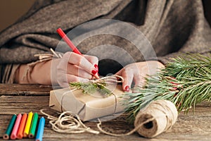 Woman`s hands wrapping christmas holiday handmade present in cra