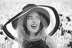 Woman`s happiness. girl in field of poppy seed in retro hat