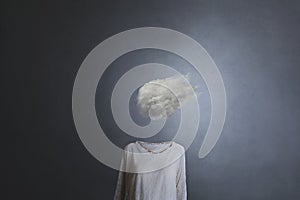 Woman`s head replaced by a white cloud photo