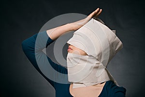 Woman's head wrapped in paper.