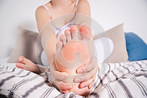 Woman`s leg hurts, pain in the foot, massage of female feet
