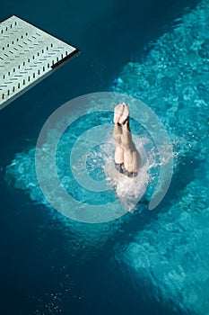 Woman's Legs Diving Into The Pool