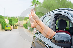 Woman's legs out of the car.