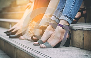 Woman`s legs in shoes rest on the step