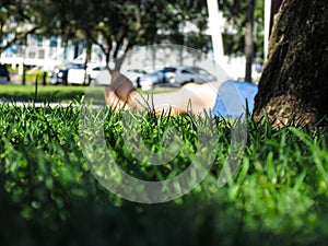 A woman`s legs stretch out on green grass