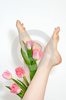 Woman& x27;s legs with tulips flowers