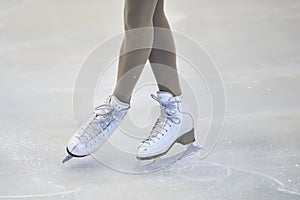 Woman's Legs in White Ice Skates