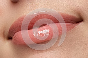 woman's lips. Beauty lips make-up. Beautiful make-up. Sensual open mouth. Lipstick and lip gloss. Natural full lips