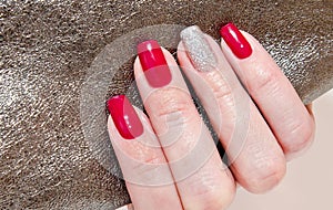 Woman`s nails with beautiful red manicure fashion design