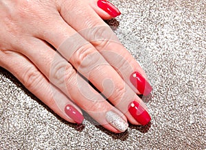 Woman`s nails with beautiful red manicure fashion design