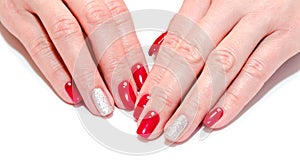 Woman`s nails with beautiful red manicure fashion design with gems isolated