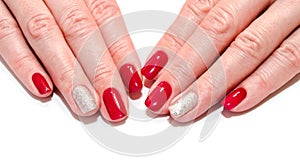 Woman`s nails with beautiful red manicure fashion design with gems isolated