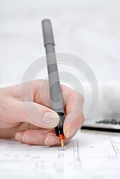 Woman`s palm holding rapidograph