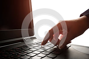Woman's palm near the laptop keyboard close-up