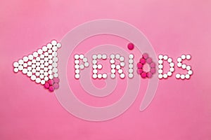 Woman`s periods concept. Inscription periods made of pain pills on pink background