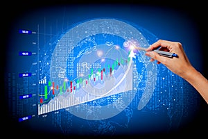 A woman\'s right hand poked a pen on a fast-growing stock chart. Globe background and blurred lights