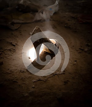 Woman`s shoe releasing smoke in a gloomy place