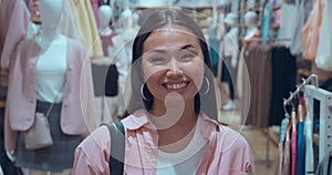 Woman's smile in clothing store close-up to pretty face capturing her joy Woman's smile pure full strong