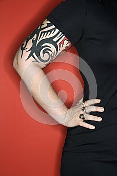 Woman's tattooed arm.