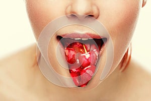 Woman's tongue. Woman with open mouth and cherry toungue.