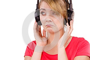 Woman sad girl in big headphones listening music