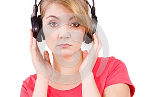 Woman sad girl in big headphones listening music