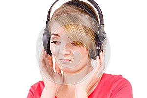 Woman sad girl in big headphones listening music