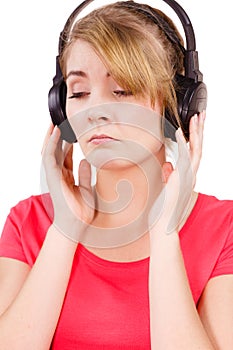 Woman sad girl in big headphones listening music