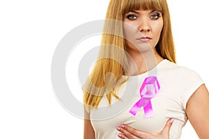 Woman sad girl wih pink cancer ribbon on chest