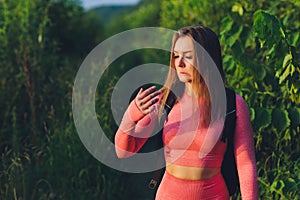 A woman with a sad suffering face shows a finger on which there is a callus, which worries her and prevents her from