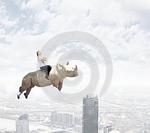 Woman saddling rhino