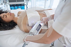 Woman during safe cosmetic procedure at beauty center