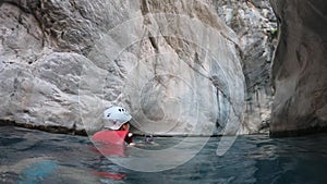 Woman in safety jacket enjoying extreme adventure hiking canyon river national park