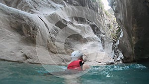 Woman in safety jacket enjoying extreme adventure hiking canyon river national park