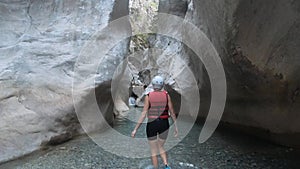 Woman in safety jacket enjoying extreme adventure hiking canyon river national park