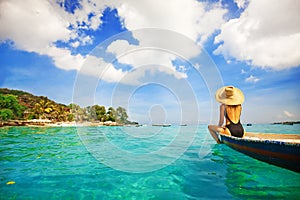 Woman sailing a boat in a paradise island