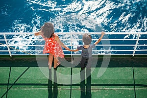 A woman is sailing on a cruise ship with her child