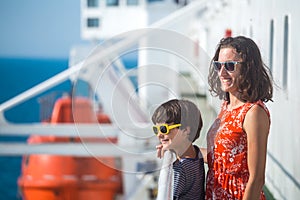 A woman is sailing on a cruise ship with her child