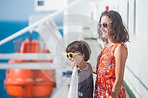 A woman is sailing on a cruise ship with her child