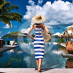 Woman sailor striped in dress near poolside